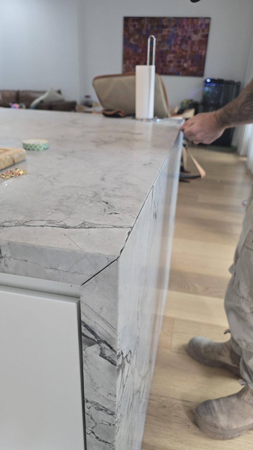 Before repair: open mitred joint along a Super White dolomite waterfall in East Lindfield