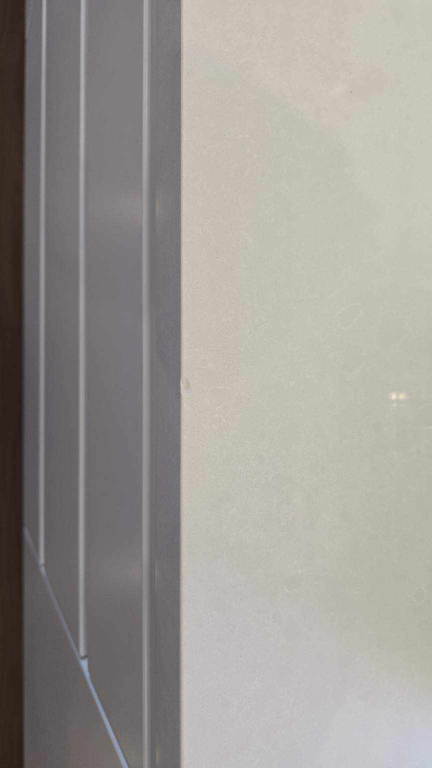 Before repair: first chip in a white Caesarstone benchtop edge in St Ives